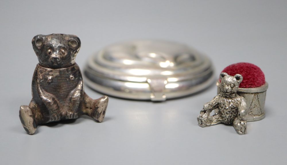 A Tiffany sterling silver circular cat compact, a white metal teddy bear pepper and a pewter teddy bear pin cushion